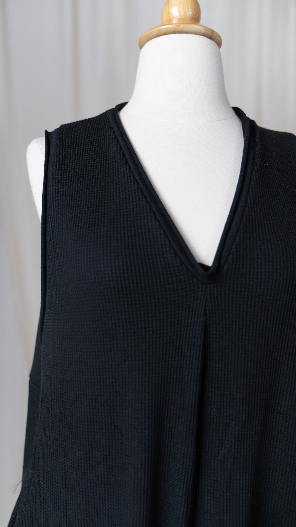 close up of black jumpsuit with v-neck