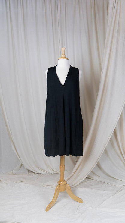 One black romper with a deep v-neck on a bust form