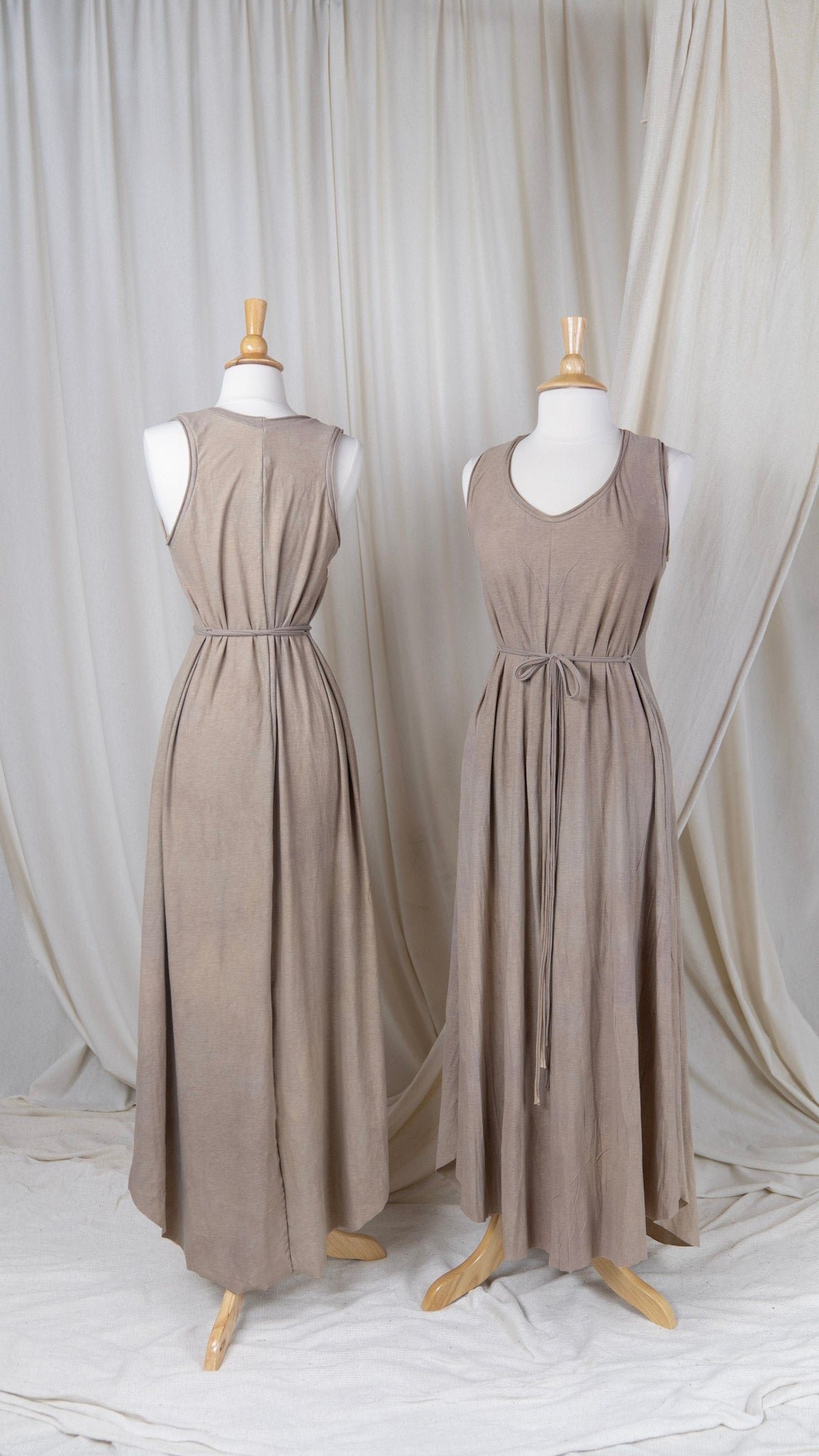 two tan dresses with a scoop neck and belted waist