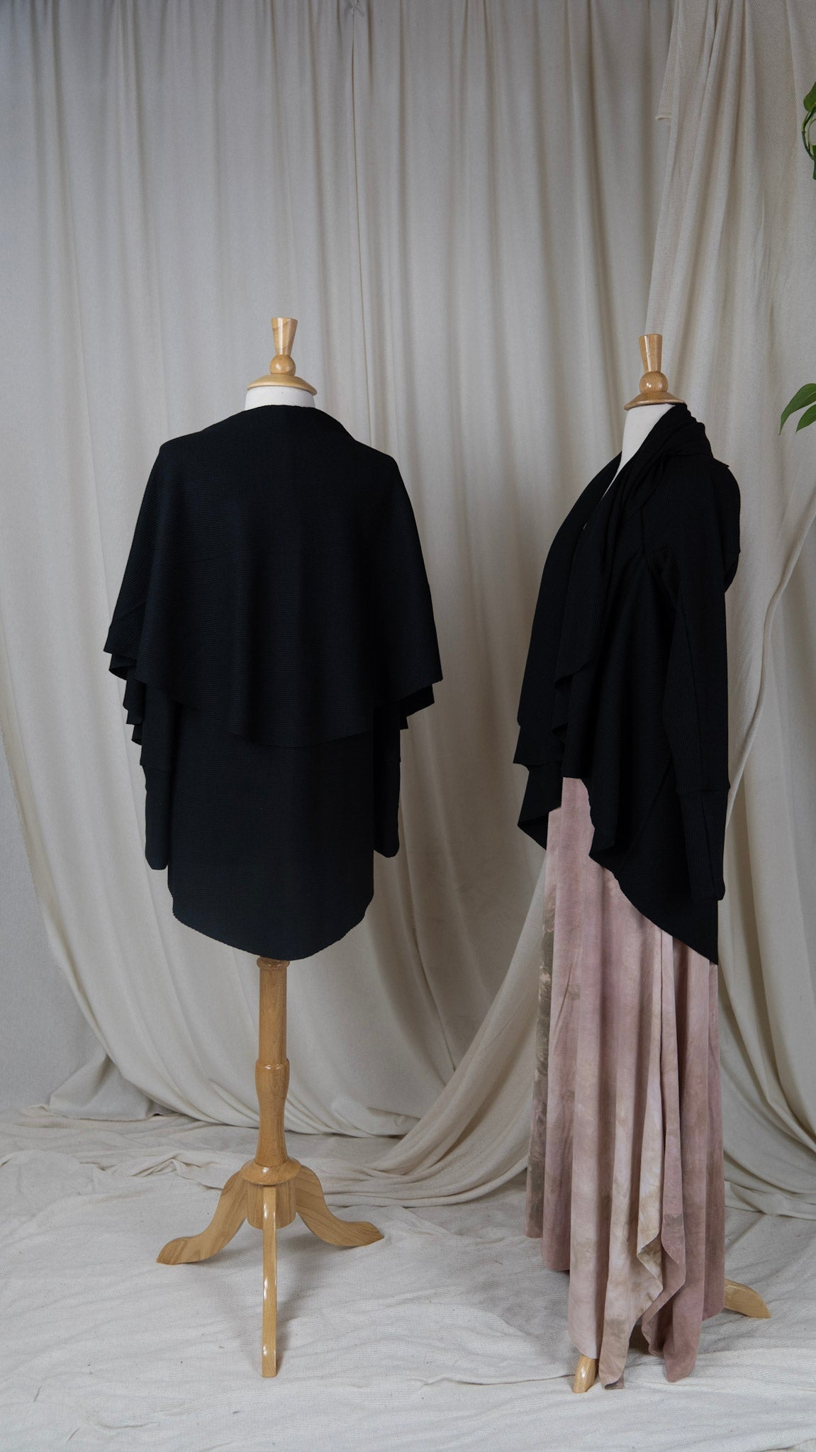 two black long sleeve cardigans styled with long light pink dress