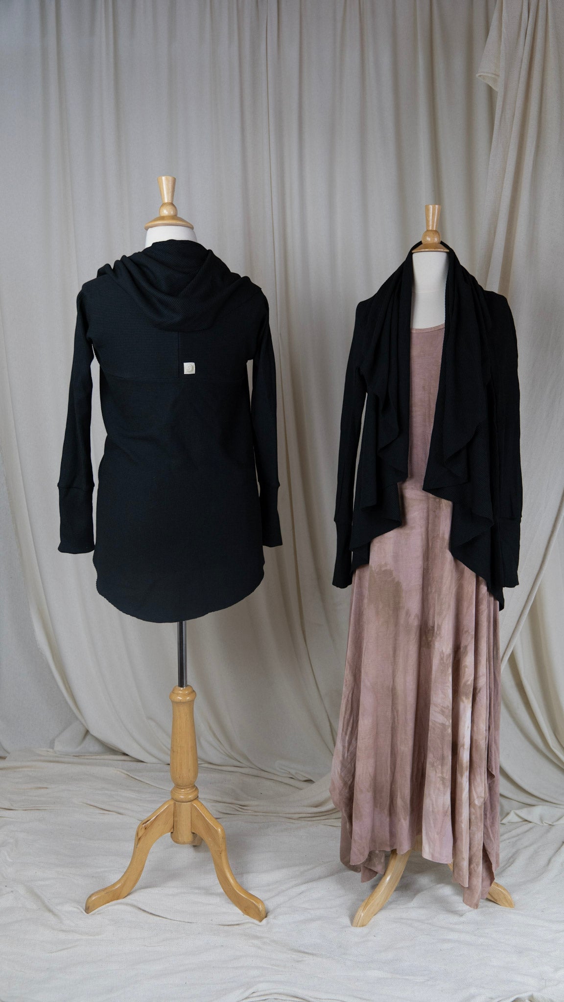 two black long sleeve cardigans styled with long light pink dress