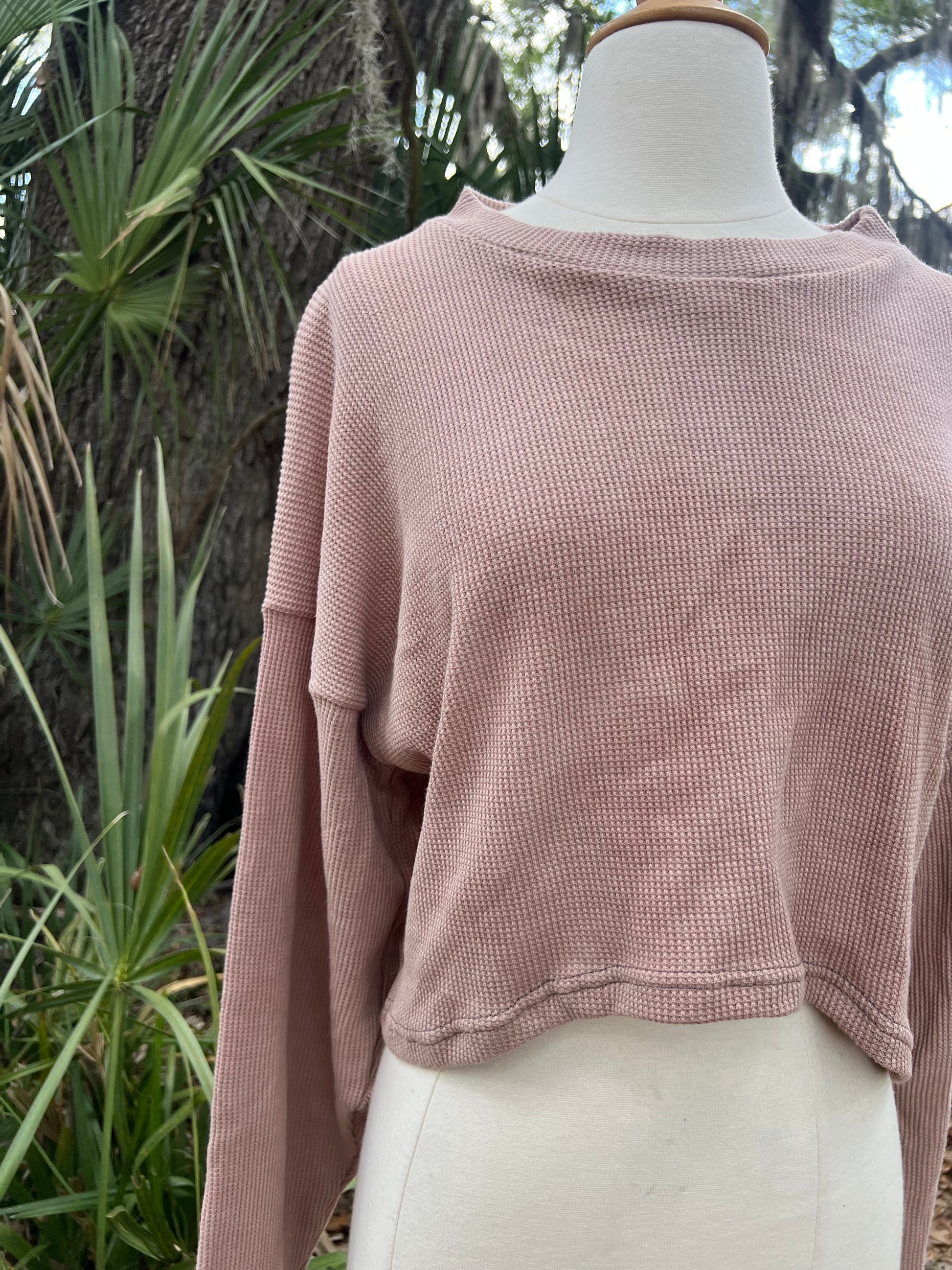Pink sweater on a mannequin with a natural background