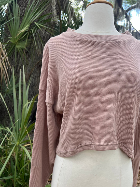 Pink sweater on a mannequin with a natural background