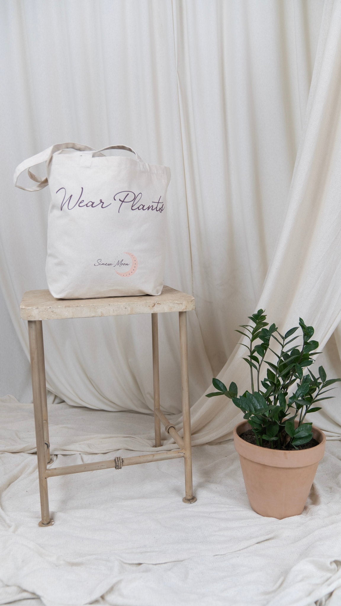 one canvas tote with the words wear plants on the front