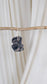 One dark and light purple dyed oversized thermal scrunchie hanging from a piece of driftwood